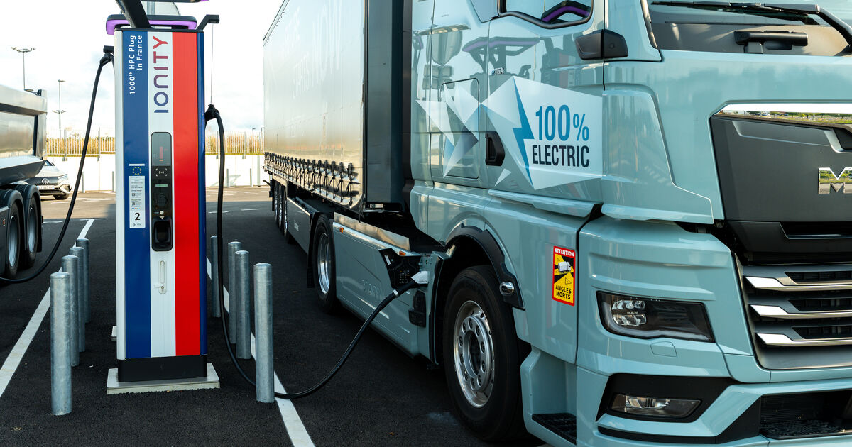 Modern electric truck connected to a charging station highlighting green transport technology and efficient charging infrastructure for battery powered vehicles. France – August 6, 2025